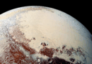 A planet with red patches and cream patches against a dark background.