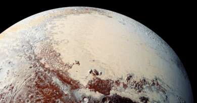 A planet with red patches and cream patches against a dark background.