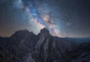 The Milky Way core streaking over a rock formation against a background of stars.