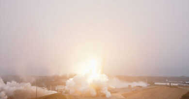 A rocket lifts into a fog layer blanketing its launch site, obscuring the view of the booster.