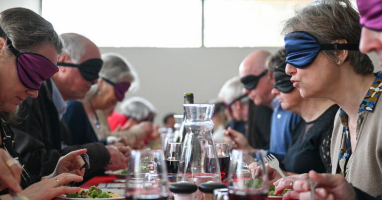 Des visiteurs de l’ESAT de Virey-le-Grand expérimentent un repas dans le noir.