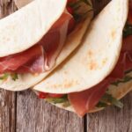 Recette traditionnelle de piadina italienne au jambon, fromage et légumes à découvrir