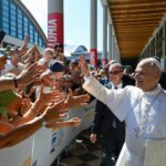 Un pape visite les allées de Rimini, suscitant des réactions parmi les fidèles.